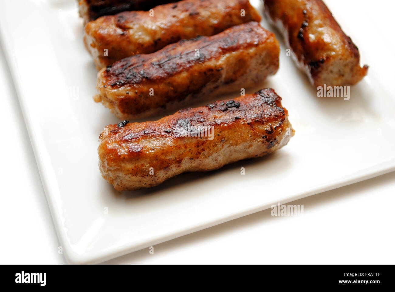 Fried Breakfast Link Sausage on a White Plate Stock Photo