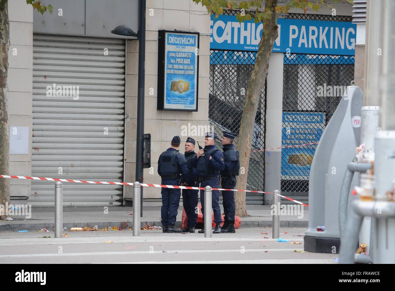 November 14th 2015. Paris, France. Police stand outside the Quick Burger restaurant. Blood can be seen spattered against the shutters and medical equipment strewn on the floor. ©Marc Ward/Alamy Stock Photo