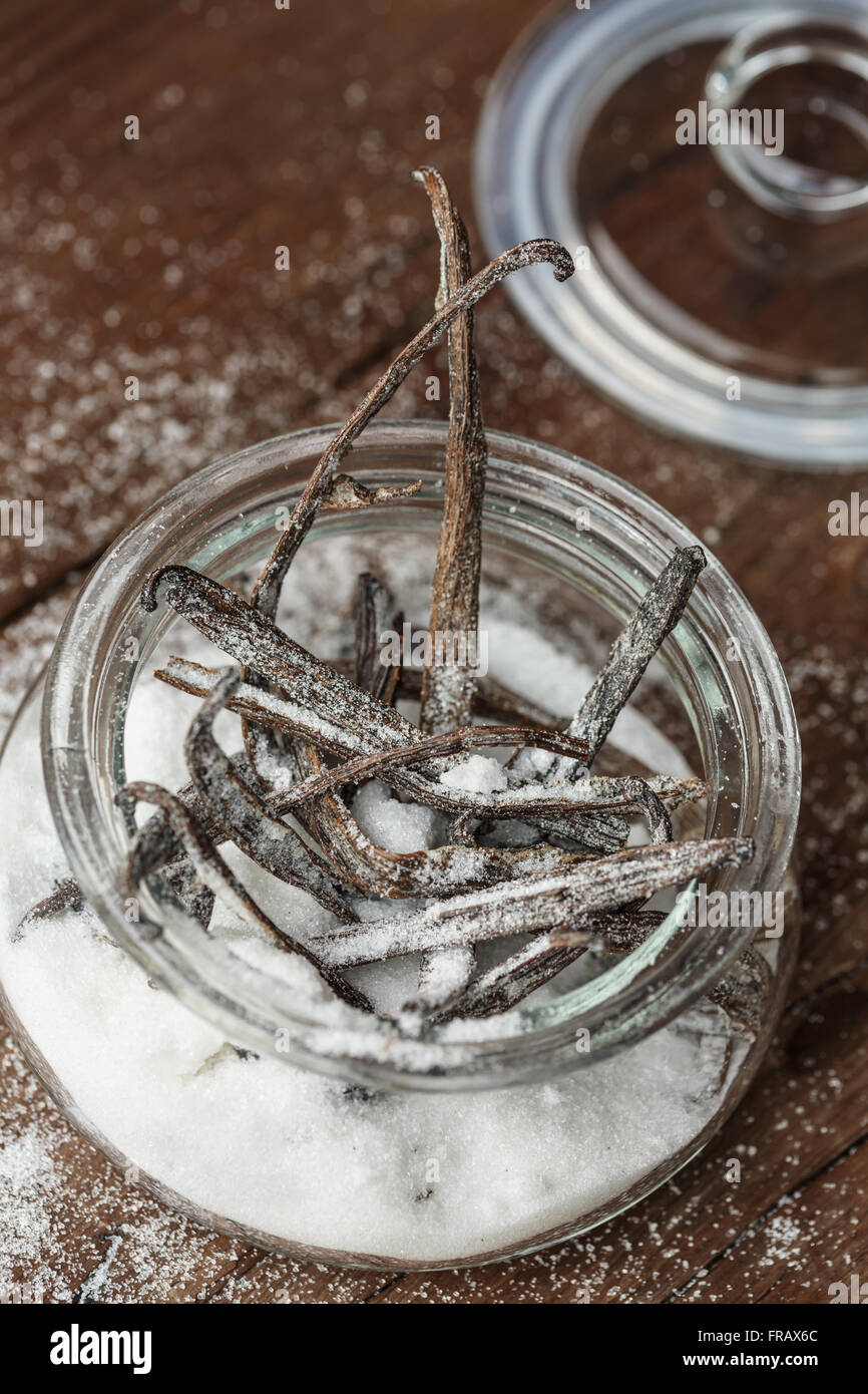 Directly above shot of  White sugar in a glass jar with vanilla sticks Stock Photo