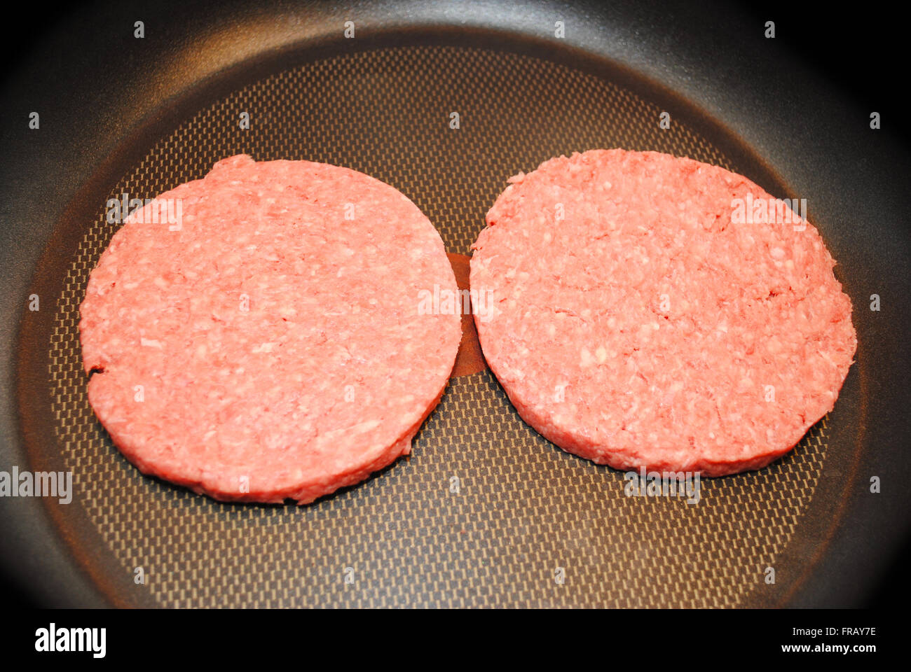 Two Raw Hamburgers Ready to Cook in a fry Pan Stock Photo Alamy