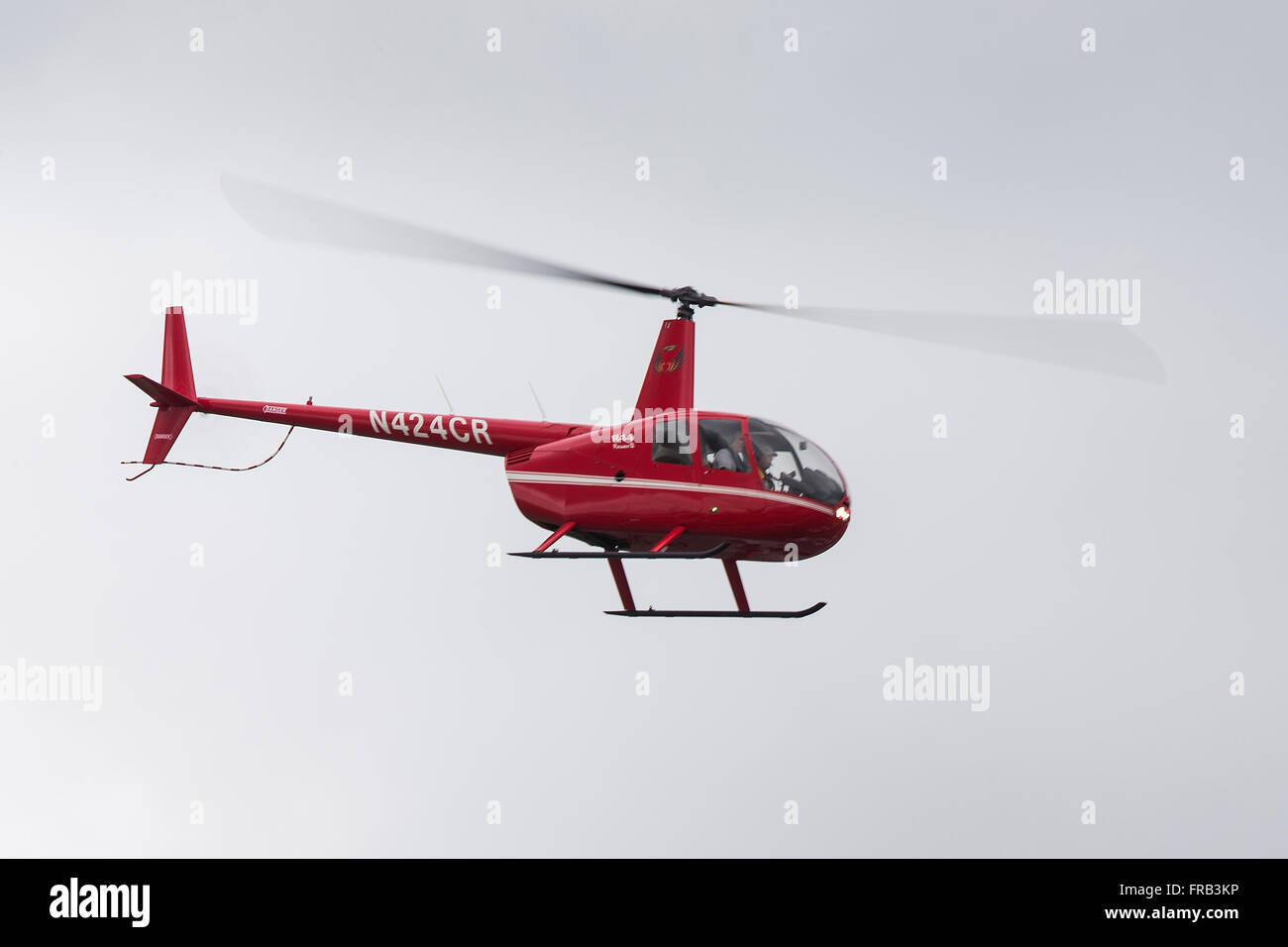 Robinson R44 Raven II (registration N424CR) helicopter flying over Palo Alto Airport (KPAO), Palo Alto, California, United States of America Stock Photo