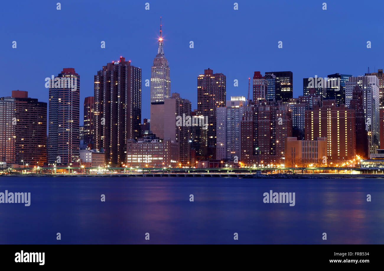 Empire State Building and midtown Manhattan as seen from Gantry State Park at sunrise in New York City, New York, United States Stock Photo