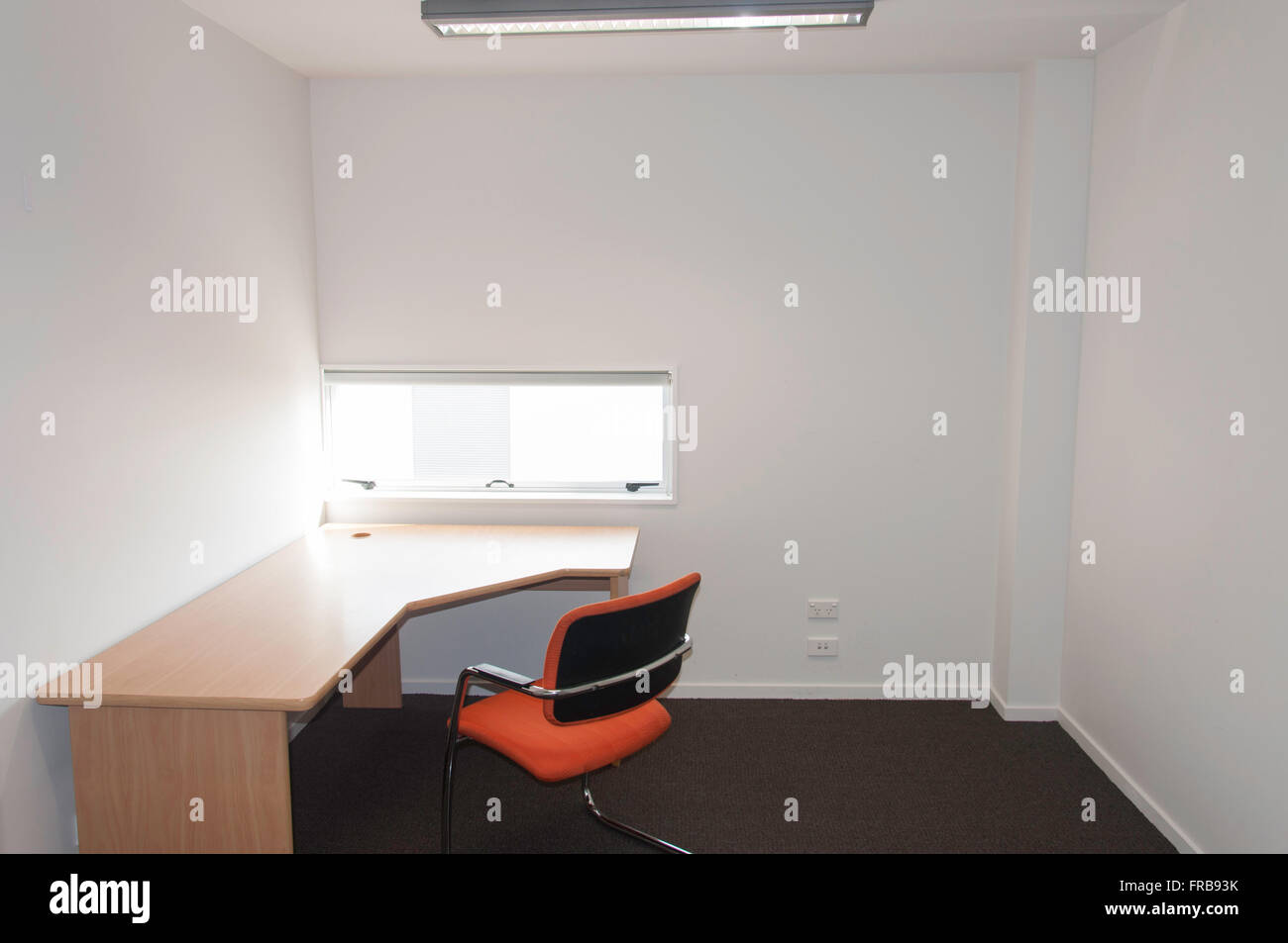 Small vacant business office with desk and chair, Christchurch, Canterbury Region, New Zealand Stock Photo