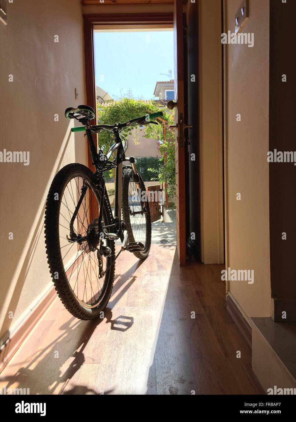 Bicycle indoor home at open door entrance Stock Photo Alamy