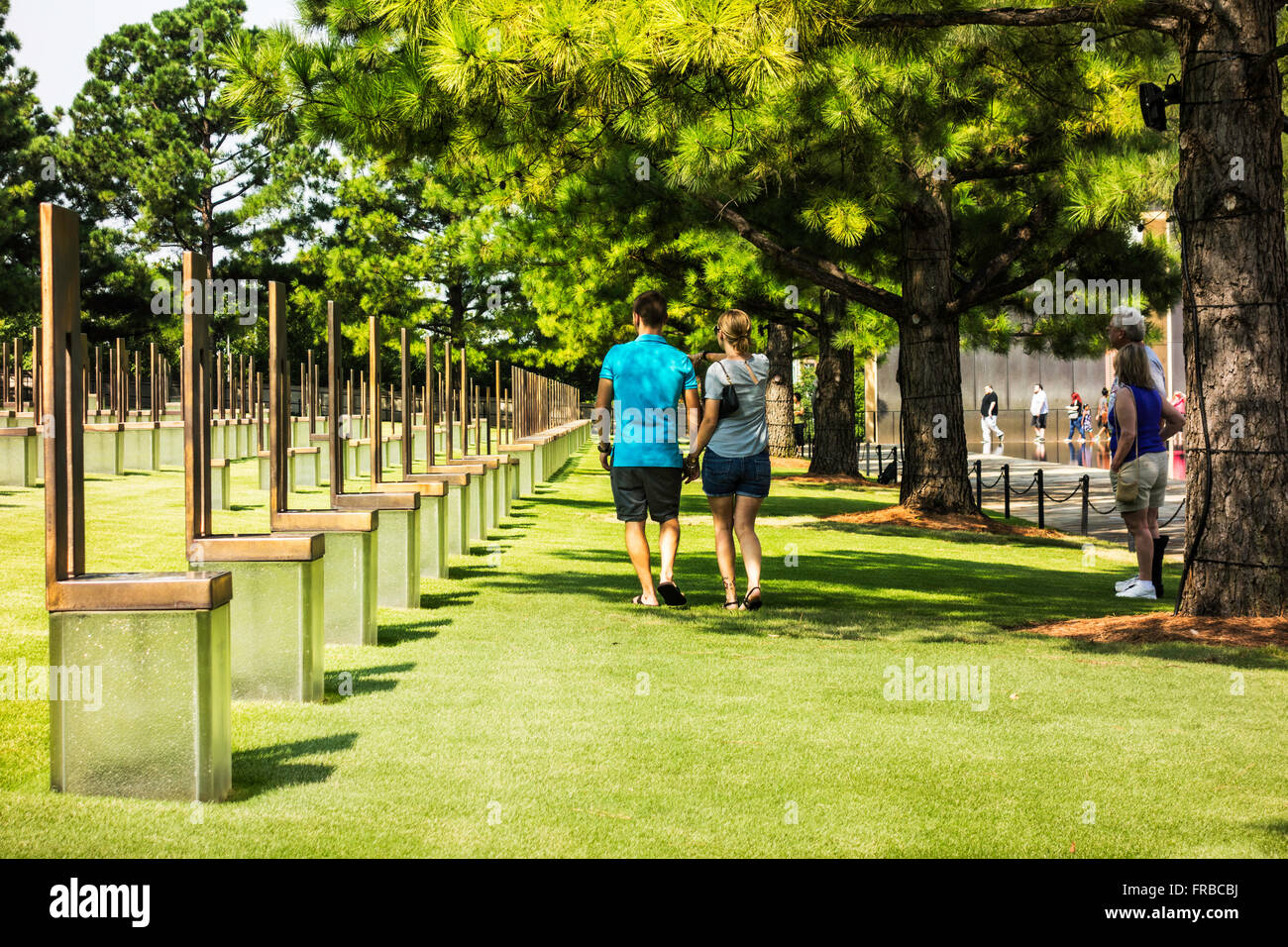 A couple strolls through the chairs honoring bombing victims at the Oklahoma City bombing memorial in Oklahoma City, Oklahoma, USA. Stock Photo