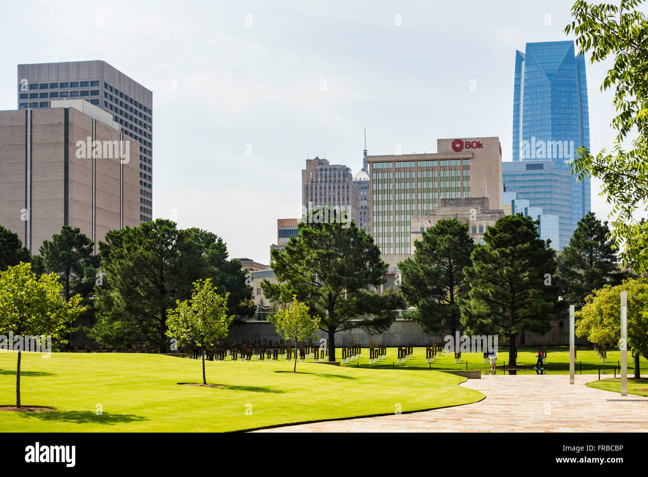 The grounds of the Oklahoma City bombing memorial, showing the Field of Chairs and city buildings. Oklahoma, USA. Stock Photo
