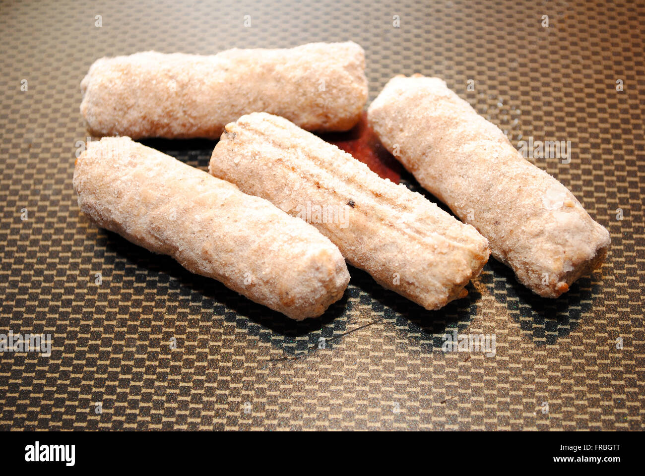 Closeup of Frozen Sausage Links in a Fry Pan Stock Photo Alamy