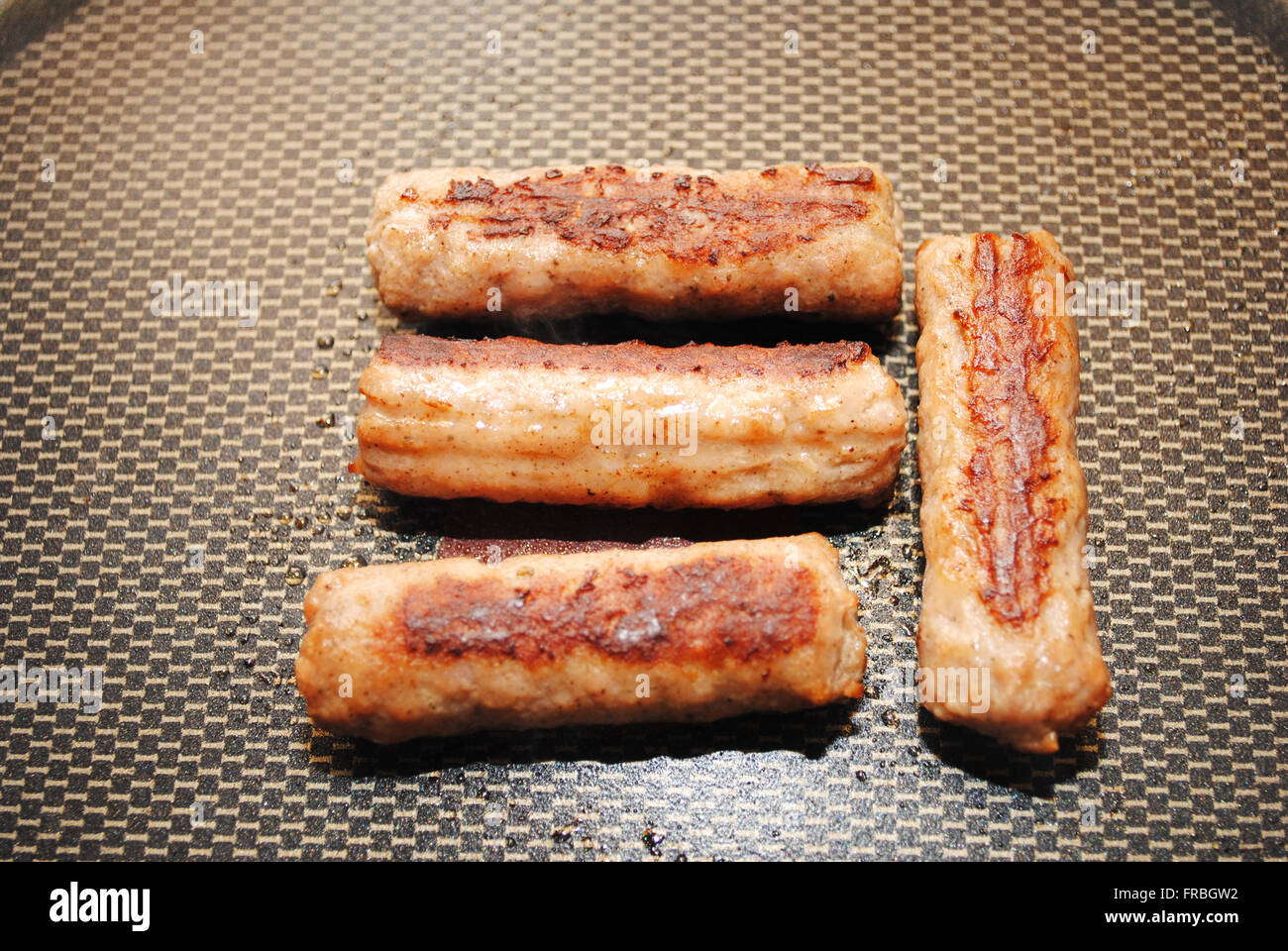 Four Sausage Links in a Fry Pan Stock Photo Alamy