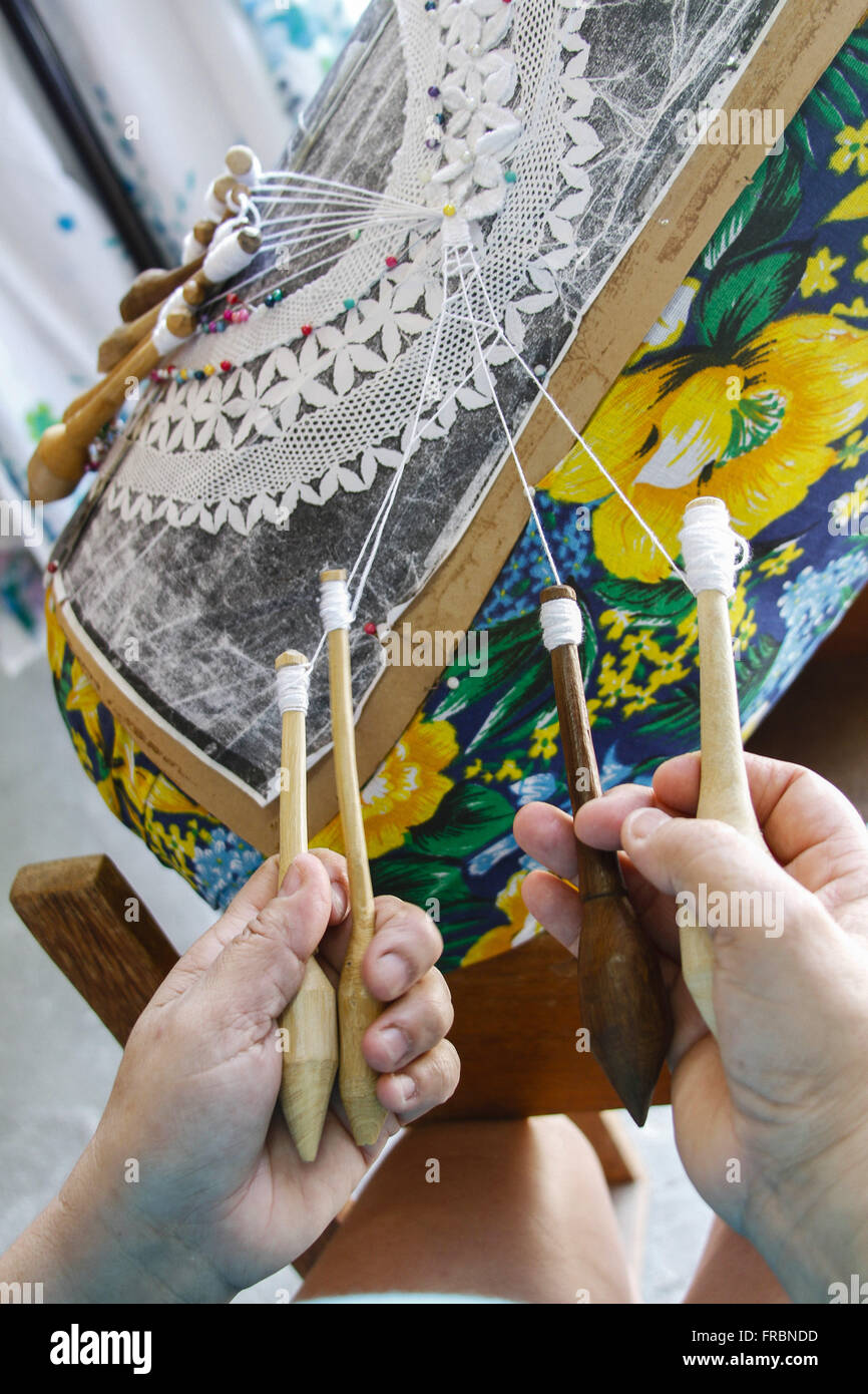 Artesa producing bobbin lace in the village of Lagoa da Conceicao Stock Photo