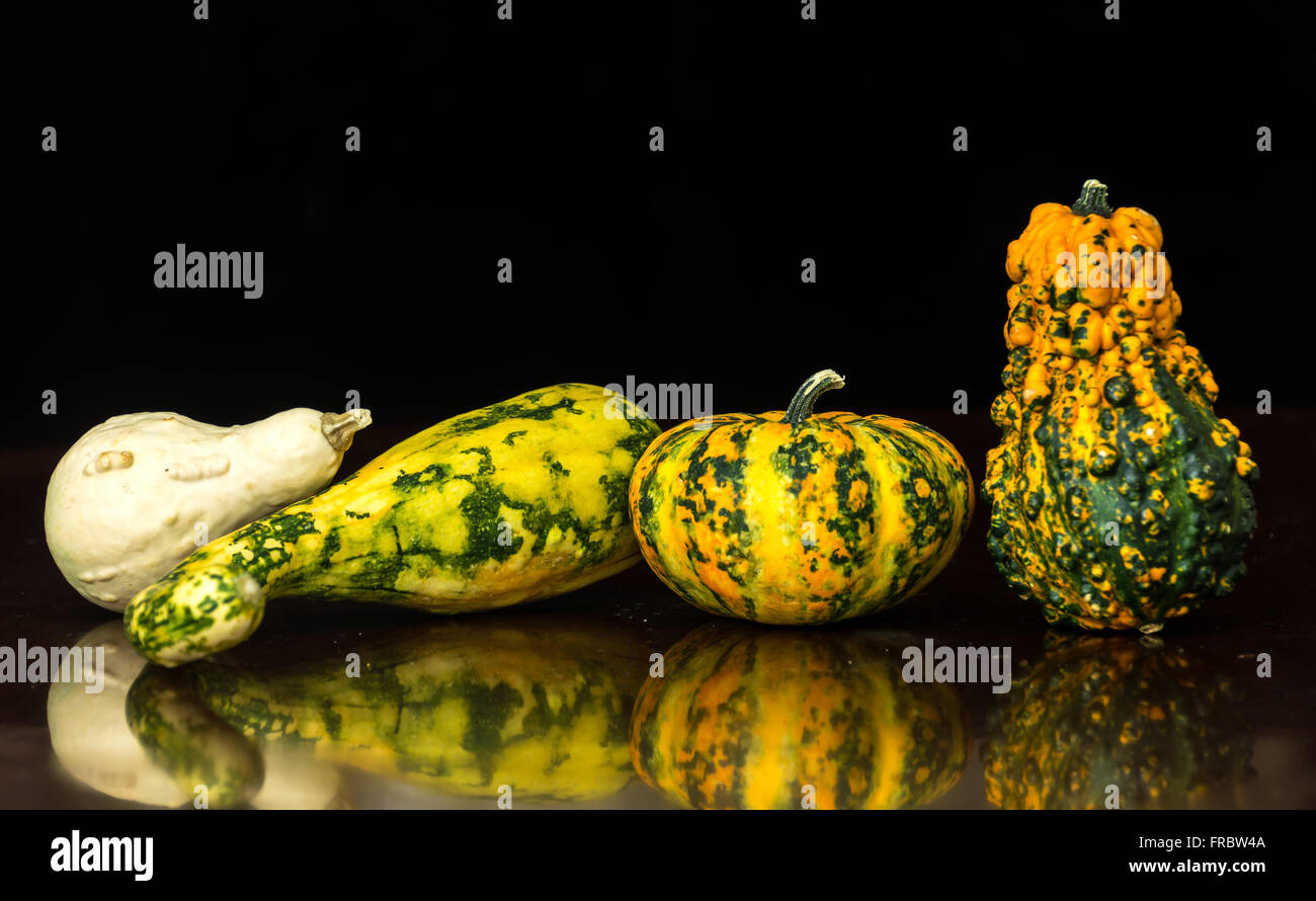 Gourds on a glass table and dark background Stock Photo - Alamy