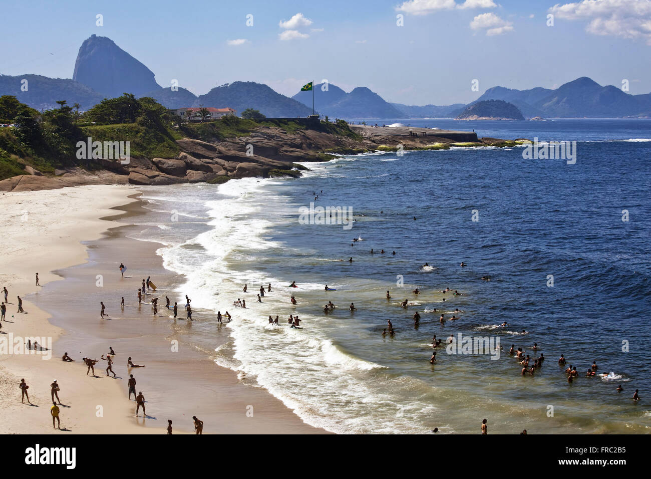 Bathers on the Beach Devil in Ipanema and Copacabana Fort in the background Stock Photo