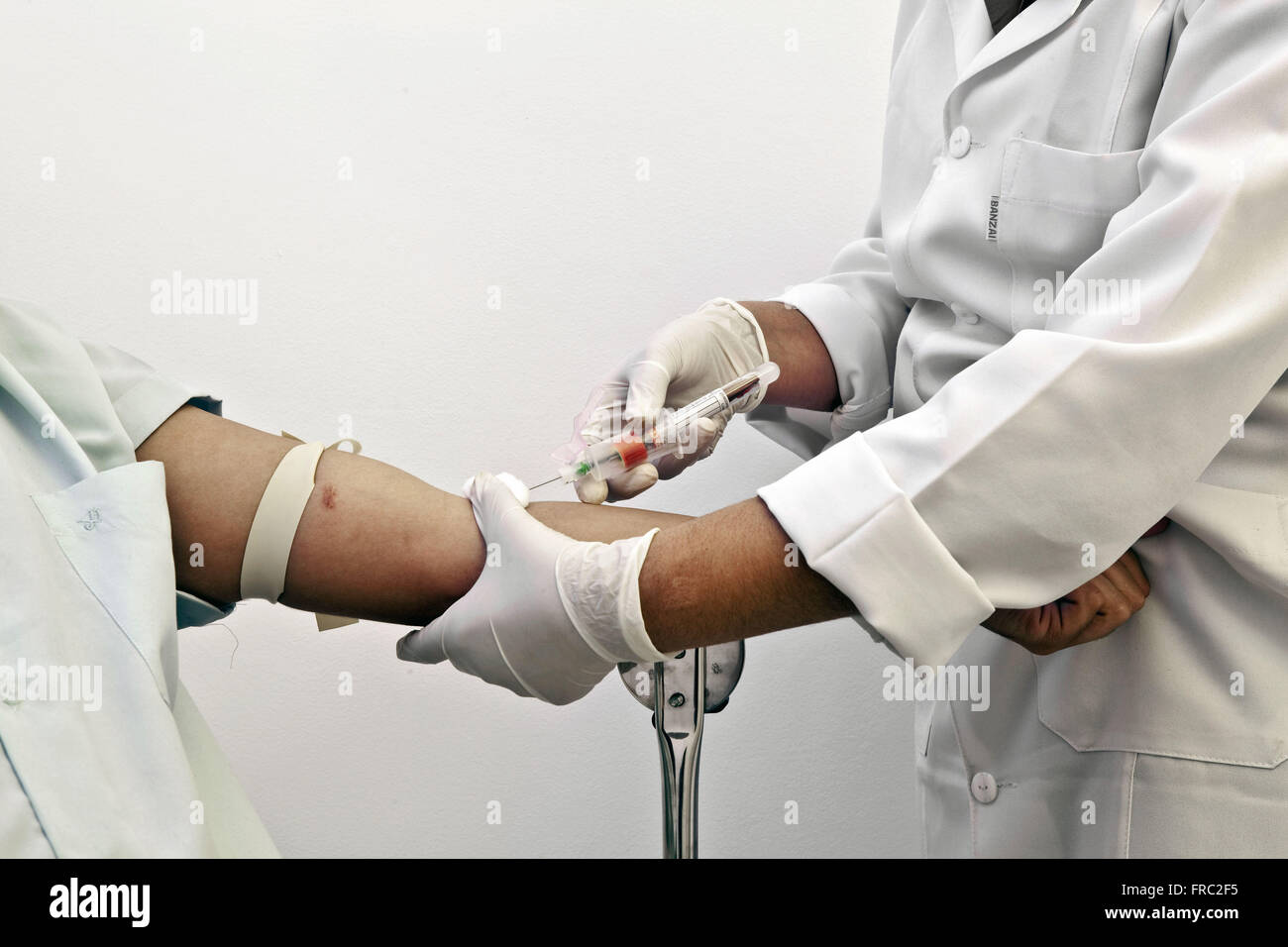 Nurse collecting blood from patient Stock Photo
