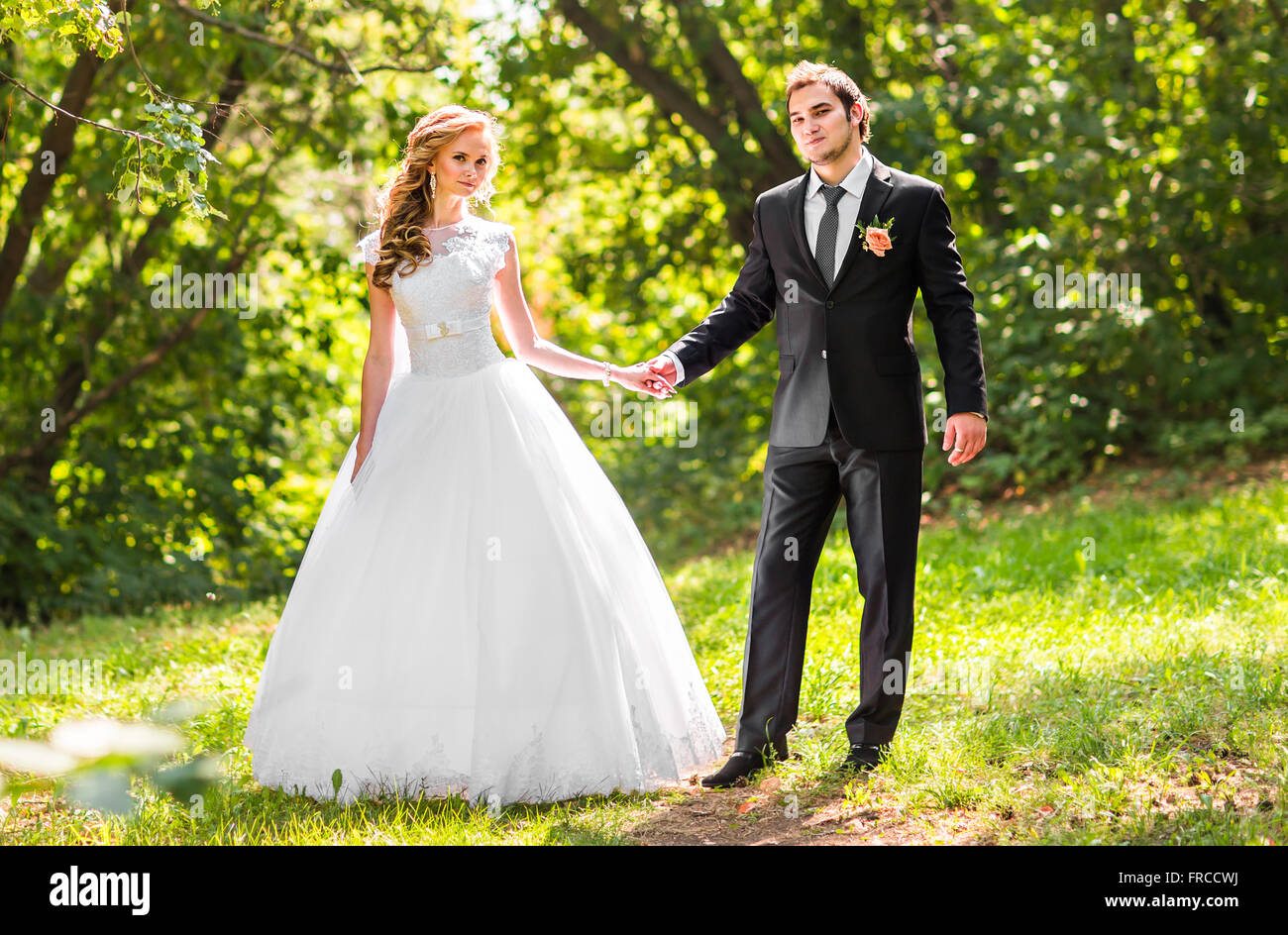wedding theme, holding hands newlyweds Stock Photo - Alamy