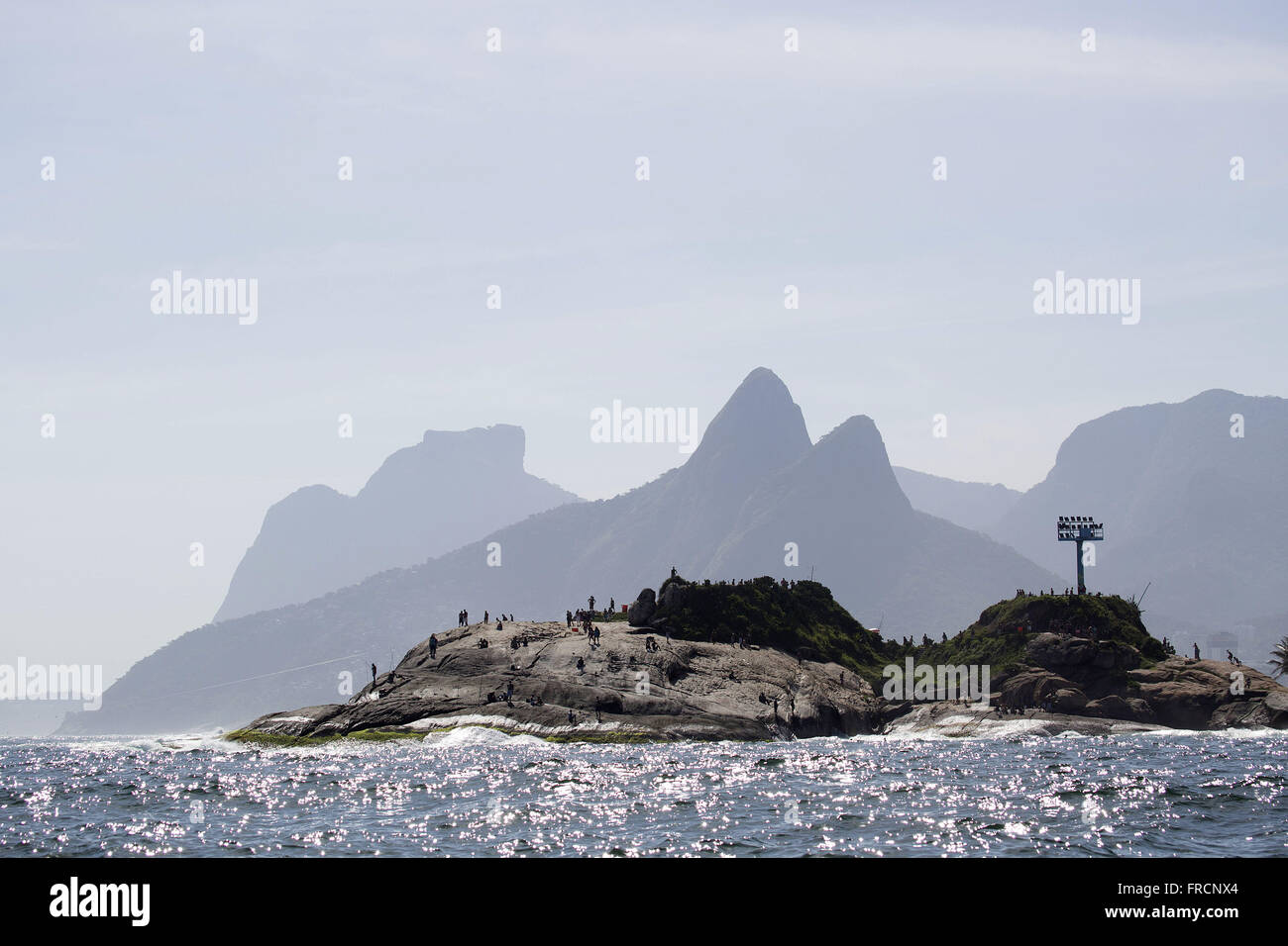 Arpoador Rock with Hill Brothers and Sugar Loaf in the background Stock Photo