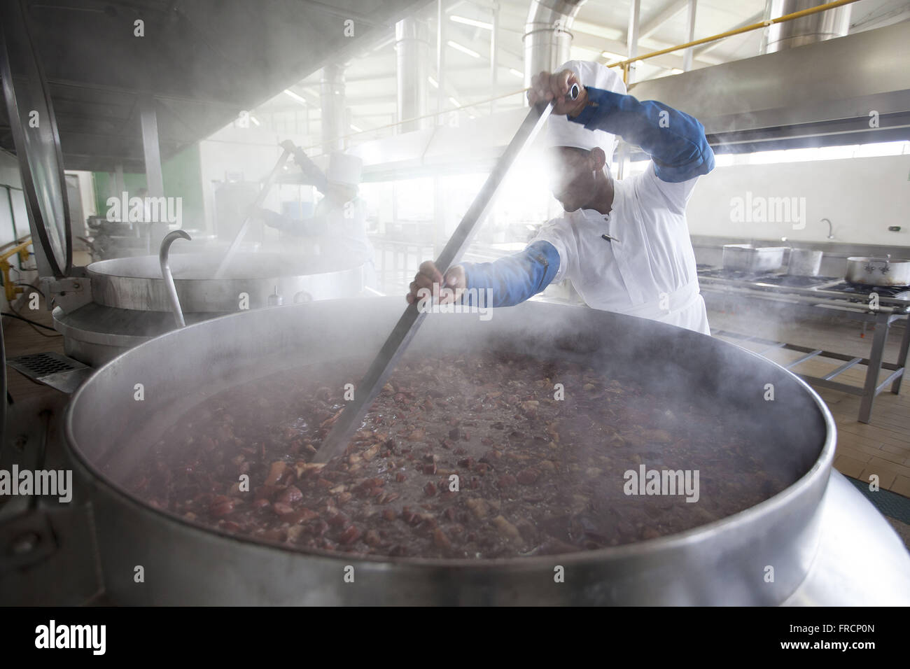 Cook prepares feijoada in boiler Stock Photo