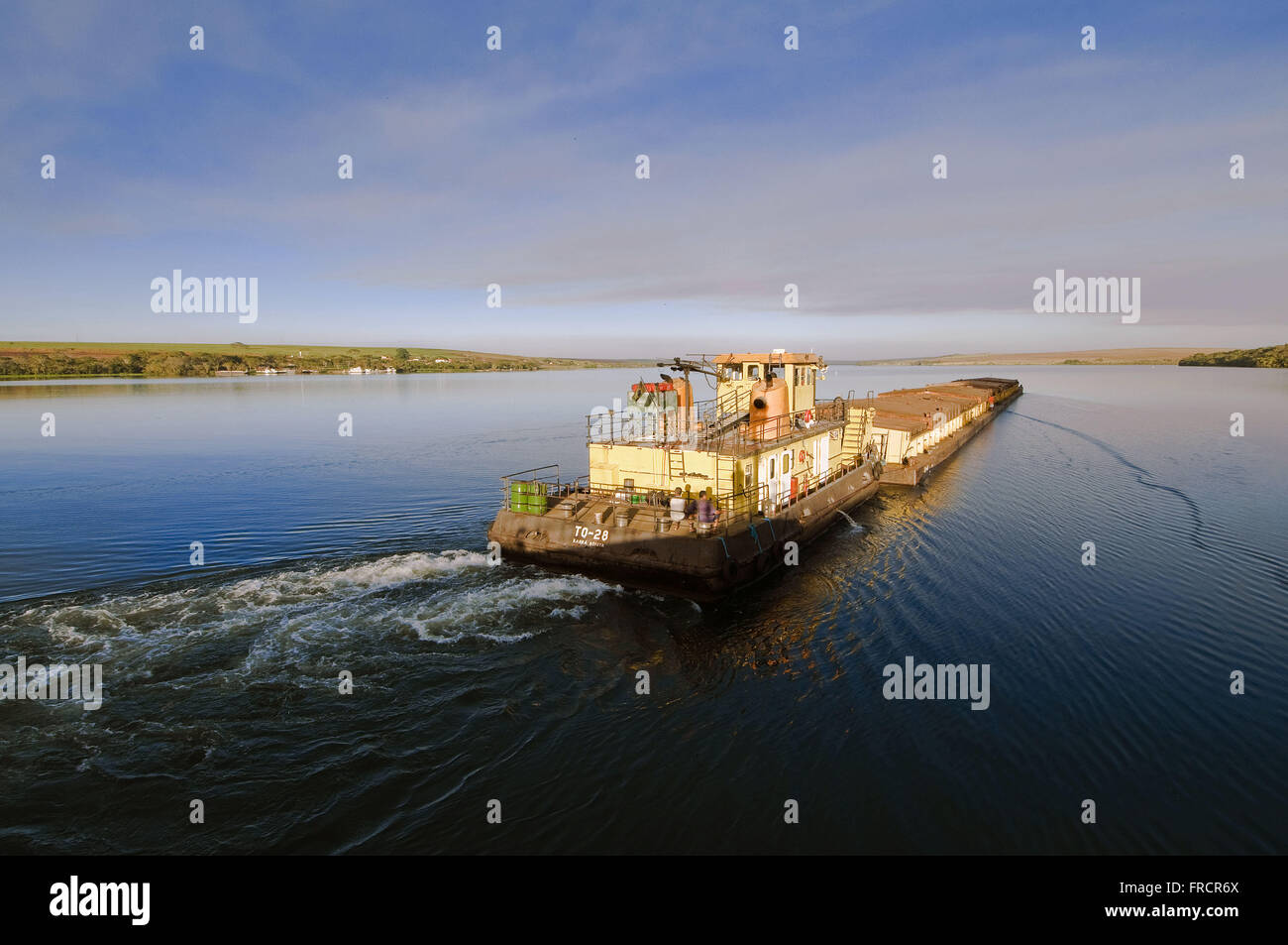 Barge loaded with soya browsing the Hydropower Plant Reservoir Bariri Stock Photo