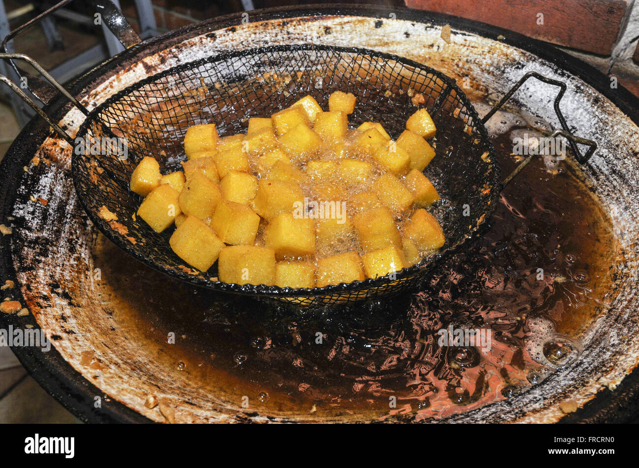 Polenta being fried in pan Stock Photo