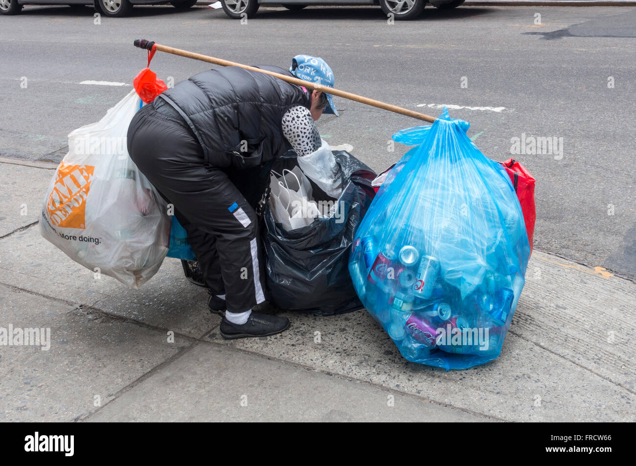 Elderly Asian woman collecting bottles and cans for the deposit in