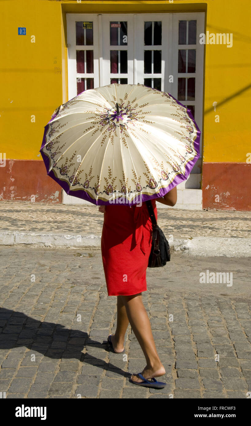 Woman protecting themselves from the sun with umbrella in the city of Cabrobo the backlands of Pernambuco Stock Photo