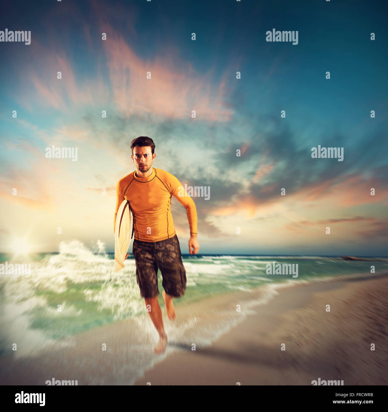 Surfer on the beach Stock Photo