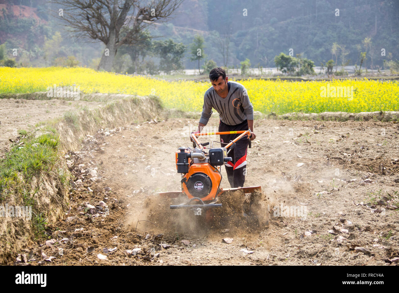 Farmer using a mini tiller in Nuwakot, Nepal Stock Photo