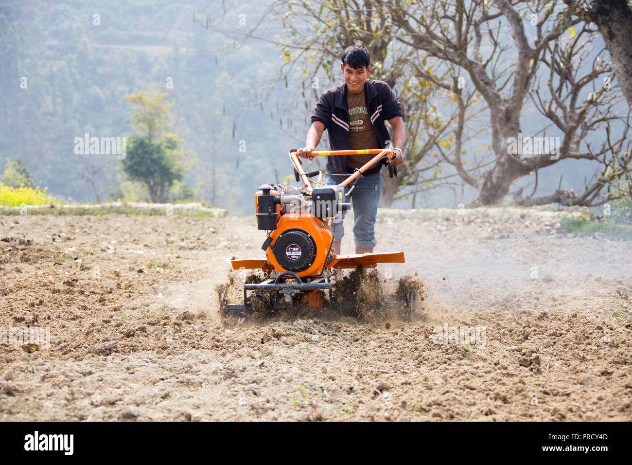 Farmer using a mini tiller in Nuwakot, Nepal Stock Photo