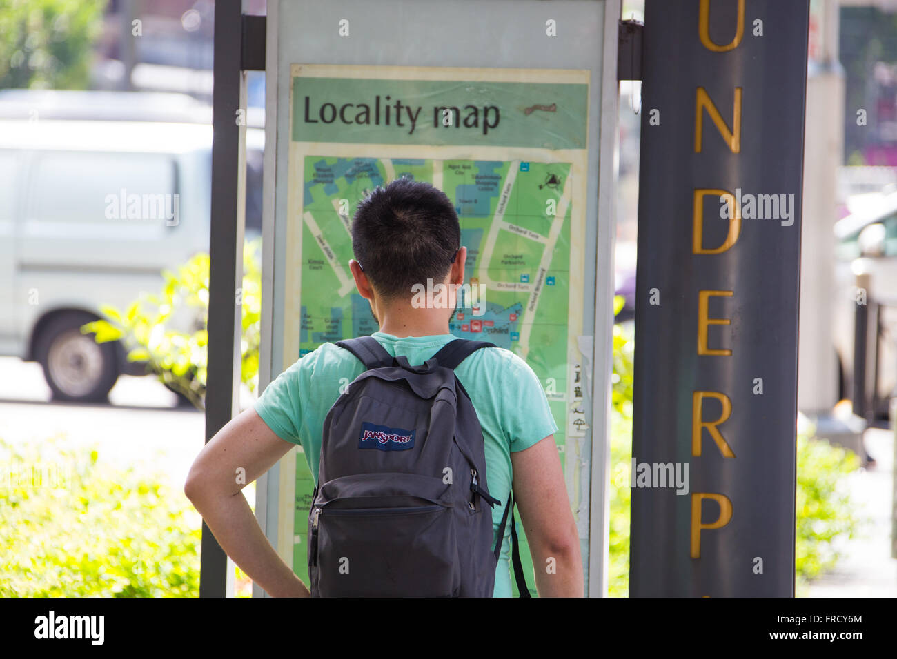 South Korean tourist looking at a Locality Map in Singapore Stock Photo