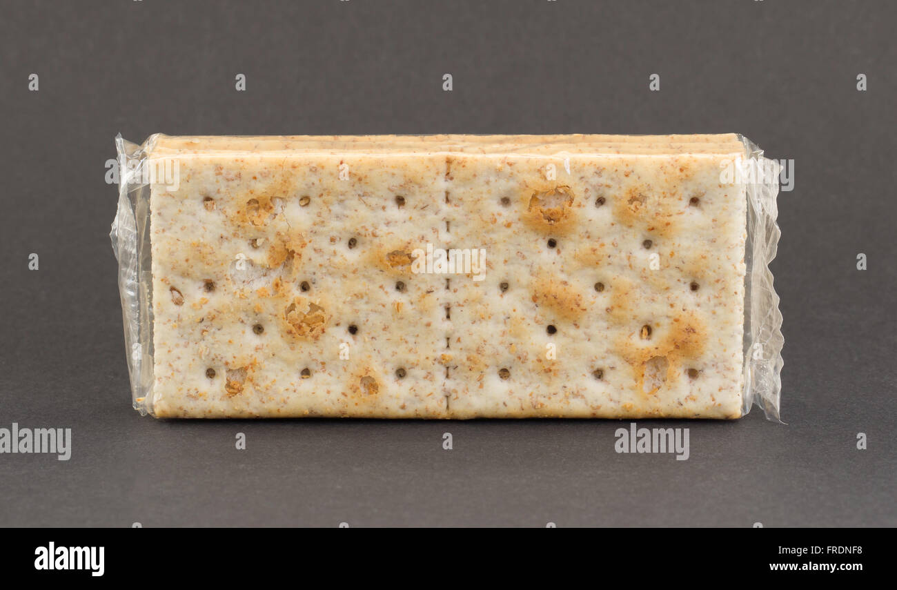 Crackers in plastic, isolated on a grey background Stock Photo - Alamy