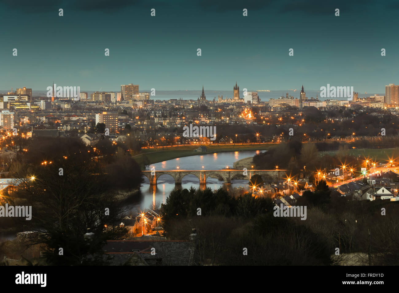 Skyline of the city of Aberdeen in Scotland, UK, at night with the River Dee in the foreground and the North Sea in background Stock Photo