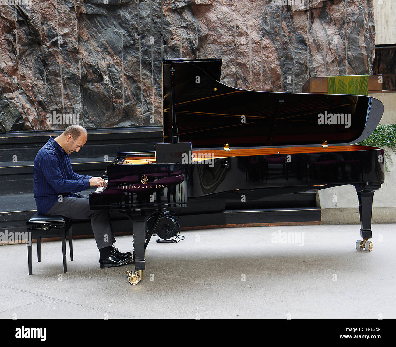 Pianist in the Temppeliaukion Kirkko, Helsinki Stock Photo