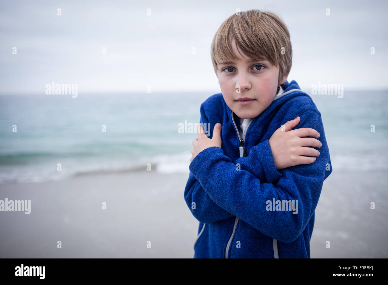 Portrait of boy in blue jacket feeling cold Stock Photo