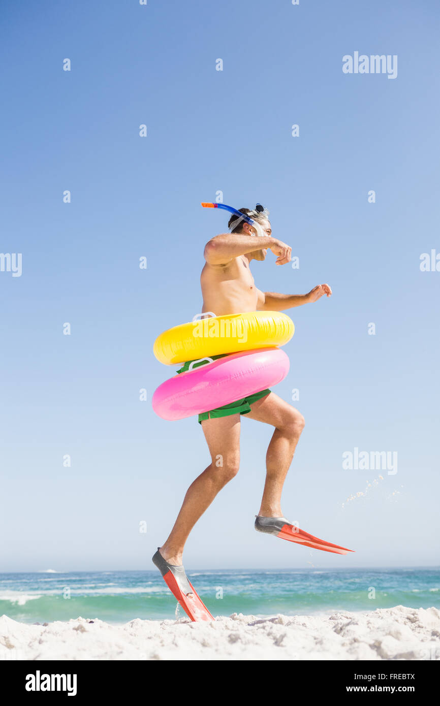 Smiling man jumping with rubber ring Stock Photo