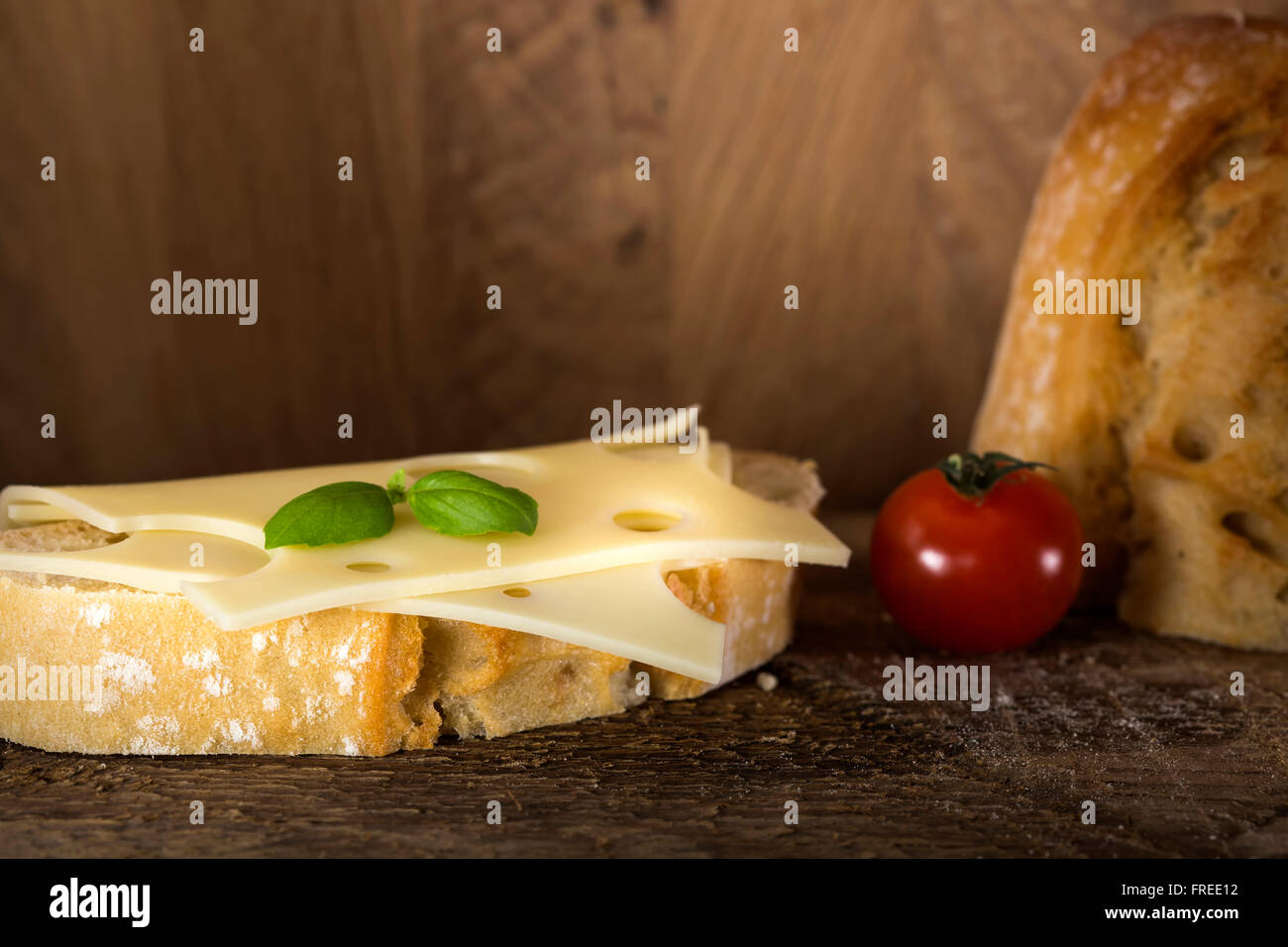 Open sandwich with emmenthal cheese on a rustic wooden background Stock Photo