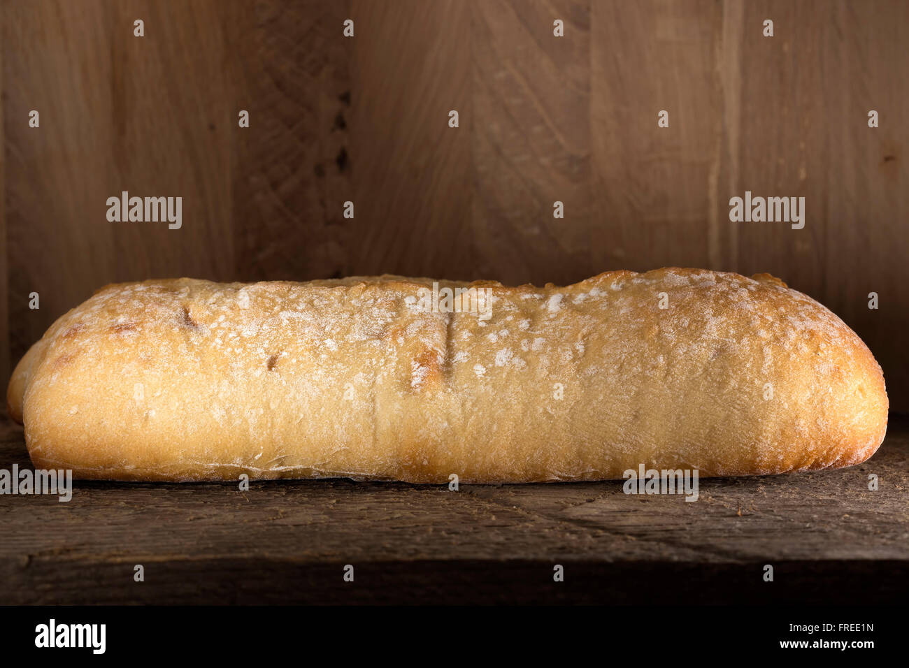 Loaf of bread on old rustic wooden background Stock Photo