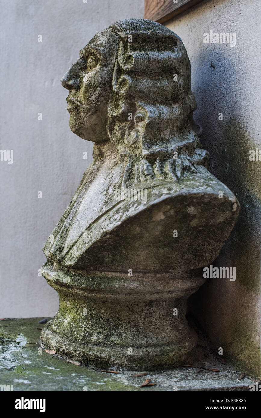 Old bust of victorian man covered with moss Stock Photo