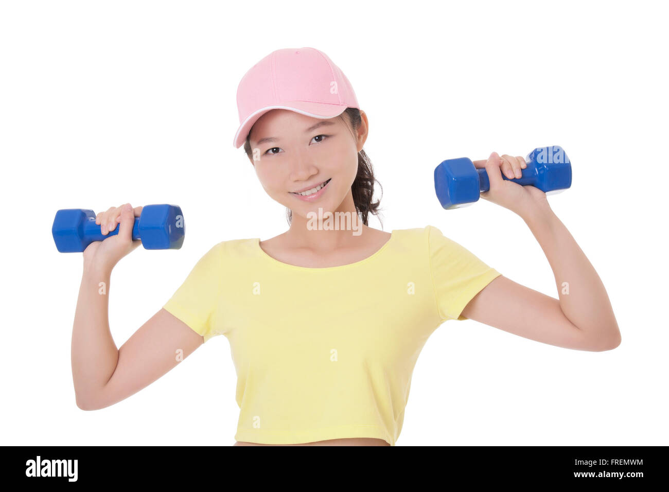 Beautiful Asian woman working out using dumbbell weights isolated on a white background Stock Photo