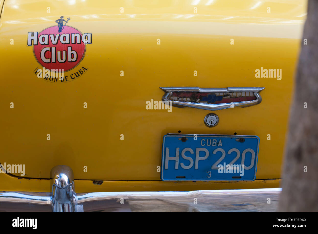 Havana Club El Ron de Cuba badge on back of yellow Chevrolet car HSP220 at Havana, Cuba, West Indies, Caribbean, Central America - Chevrolet logo Stock Photo