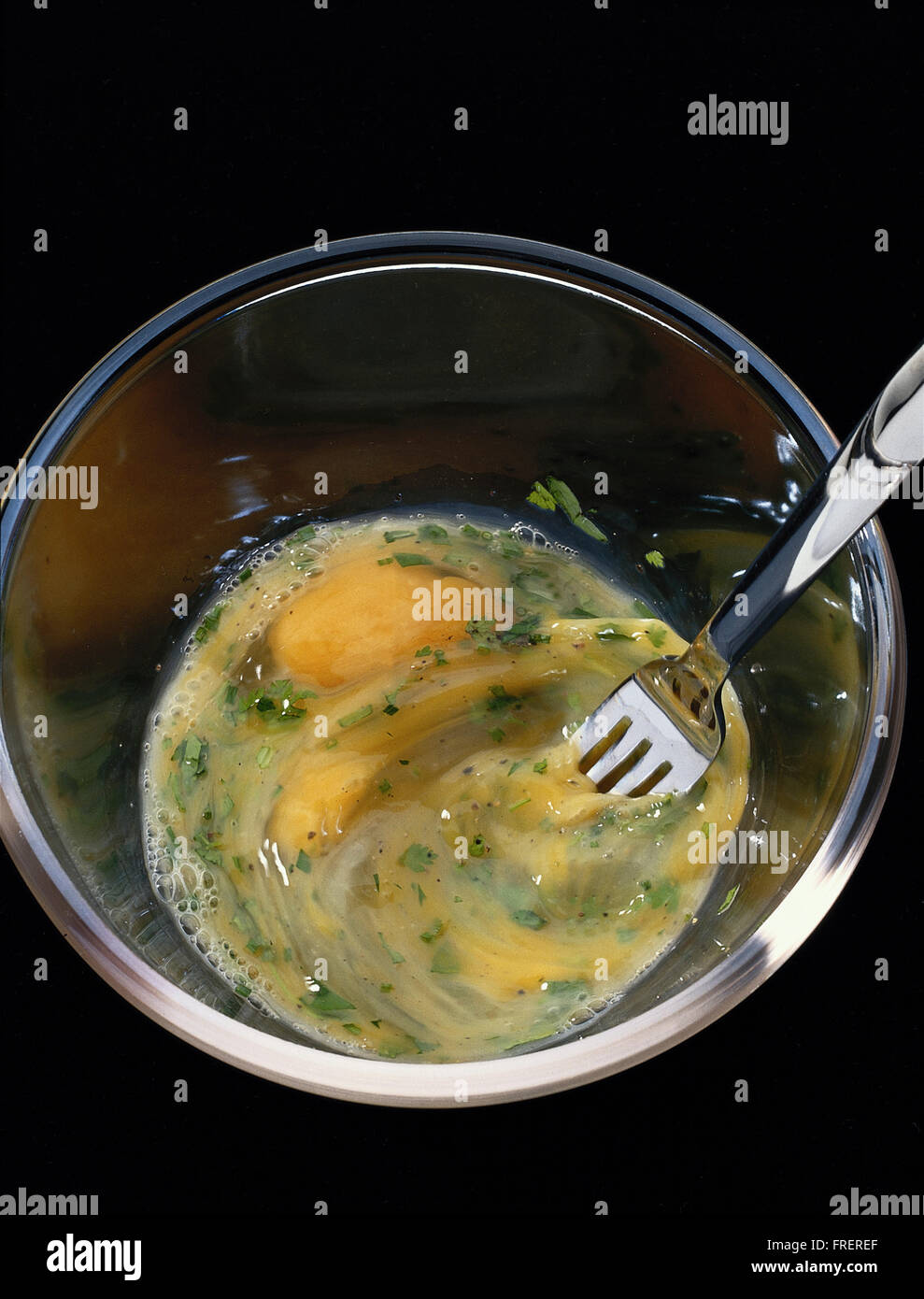 Classic french omelette: 1,eggs being stirred with a fork. Stock Photo