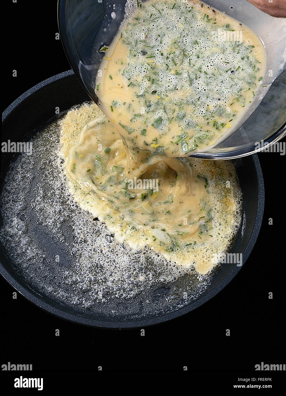 Classic french omelette: 3, egg mixture being poured into the pan. Stock Photo