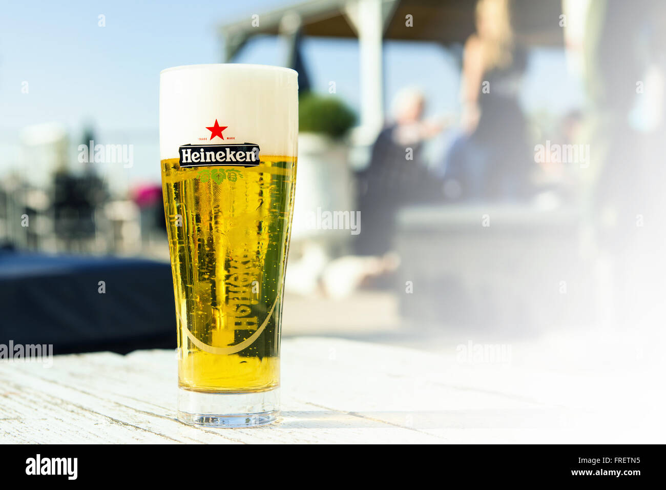 Glass of Heineken beer on a wooden table Stock Photo