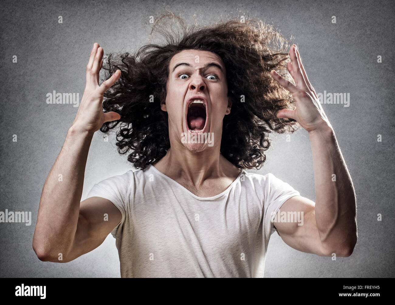 Young guy facing a mental collapse with a desperate expression Stock Photo