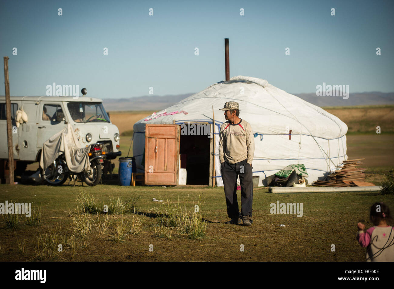 A man stands outside his ger (yurt) on the Mongolian steppe Stock Photo ...