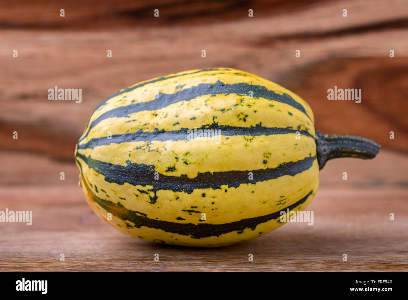small decorative green and yellow pumpkin on wood Stock Photo - Alamy