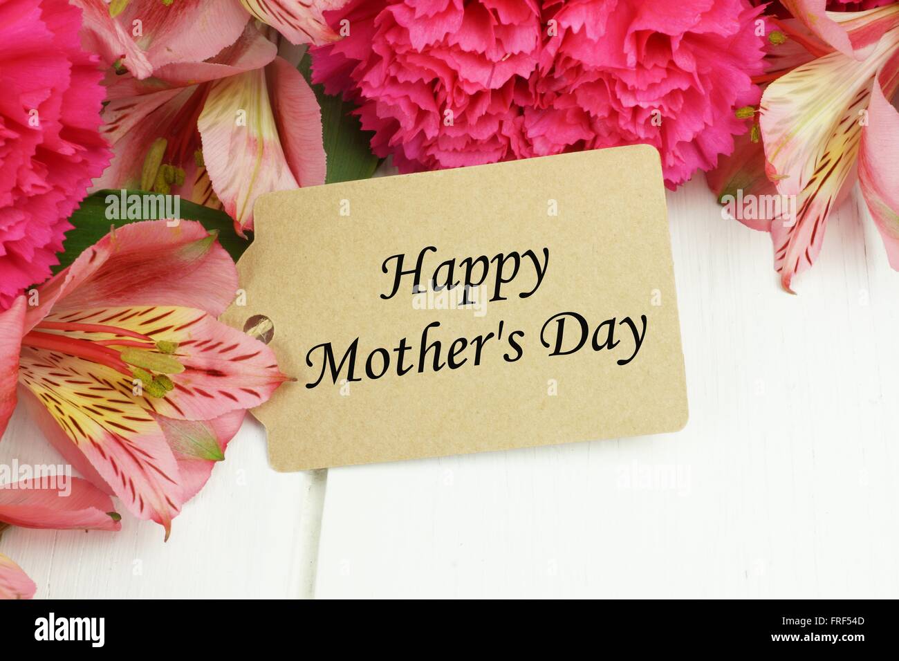 Happy Mother S Day Gift Close Up With Pink Carnation And Lily Flowers Against White Wood Background Stock Photo Alamy