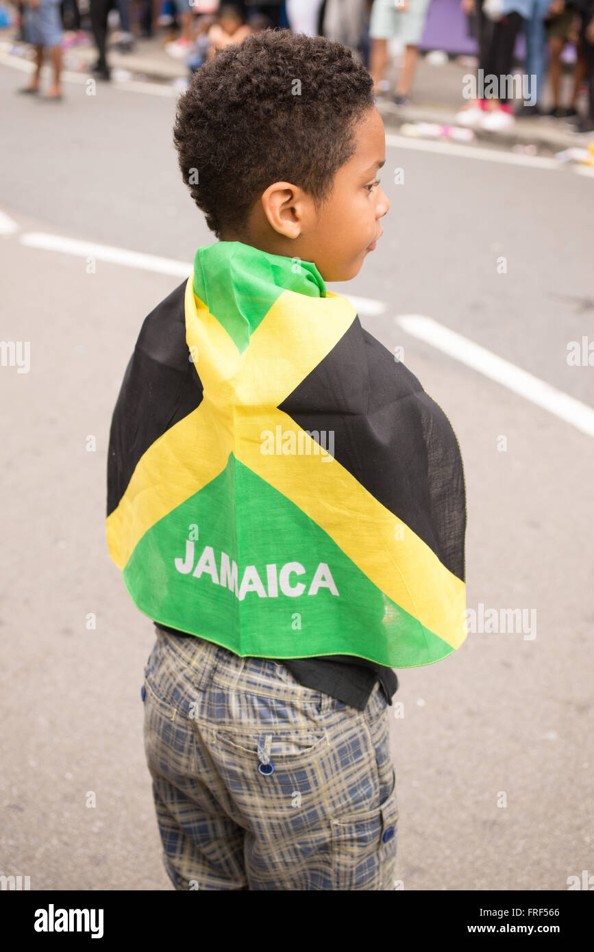 Afro-american Boy wrapped in a Jamaica flag during the street parade for the Notting Hill Carnival Stock Photo