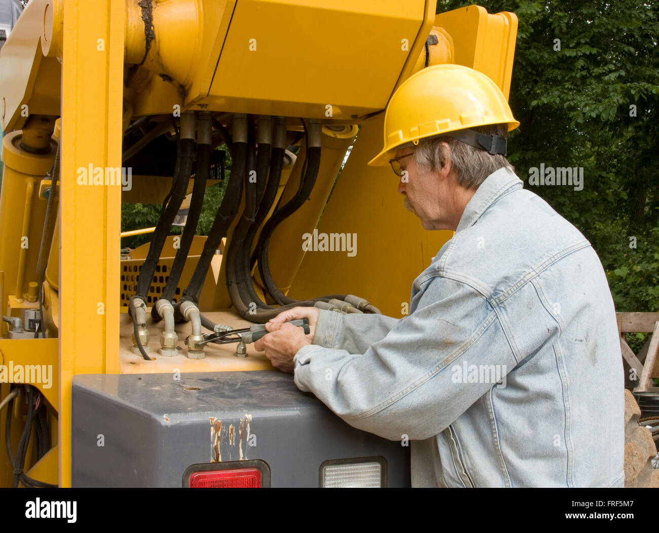 heavy equipment mechanic repairing hydraulic hoses Stock Photo Alamy
