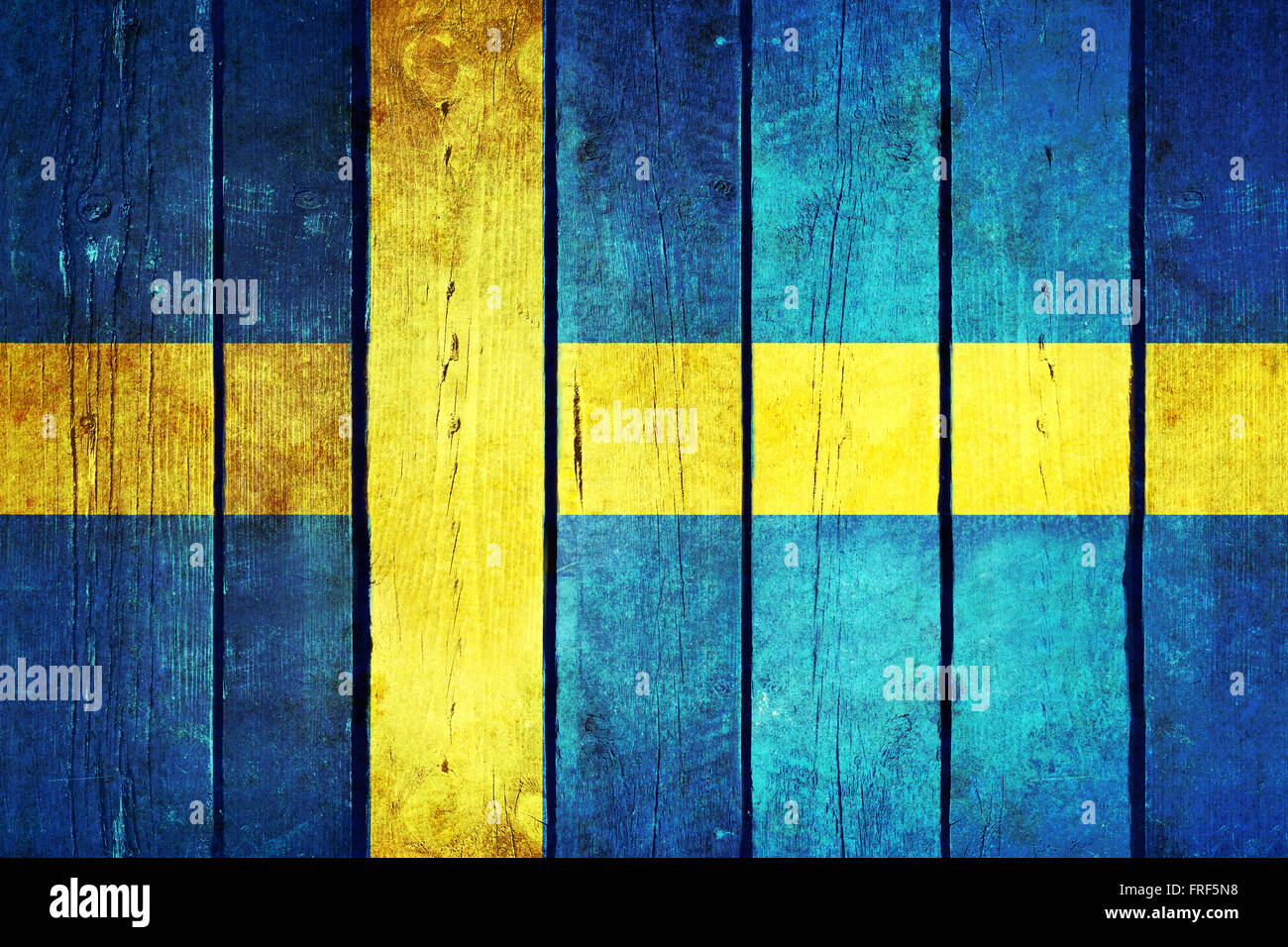 Sweden wooden grunge flag. Sweden flag painted on the old wooden planks. Vintage retro picture from my collection of flags. Stock Photo