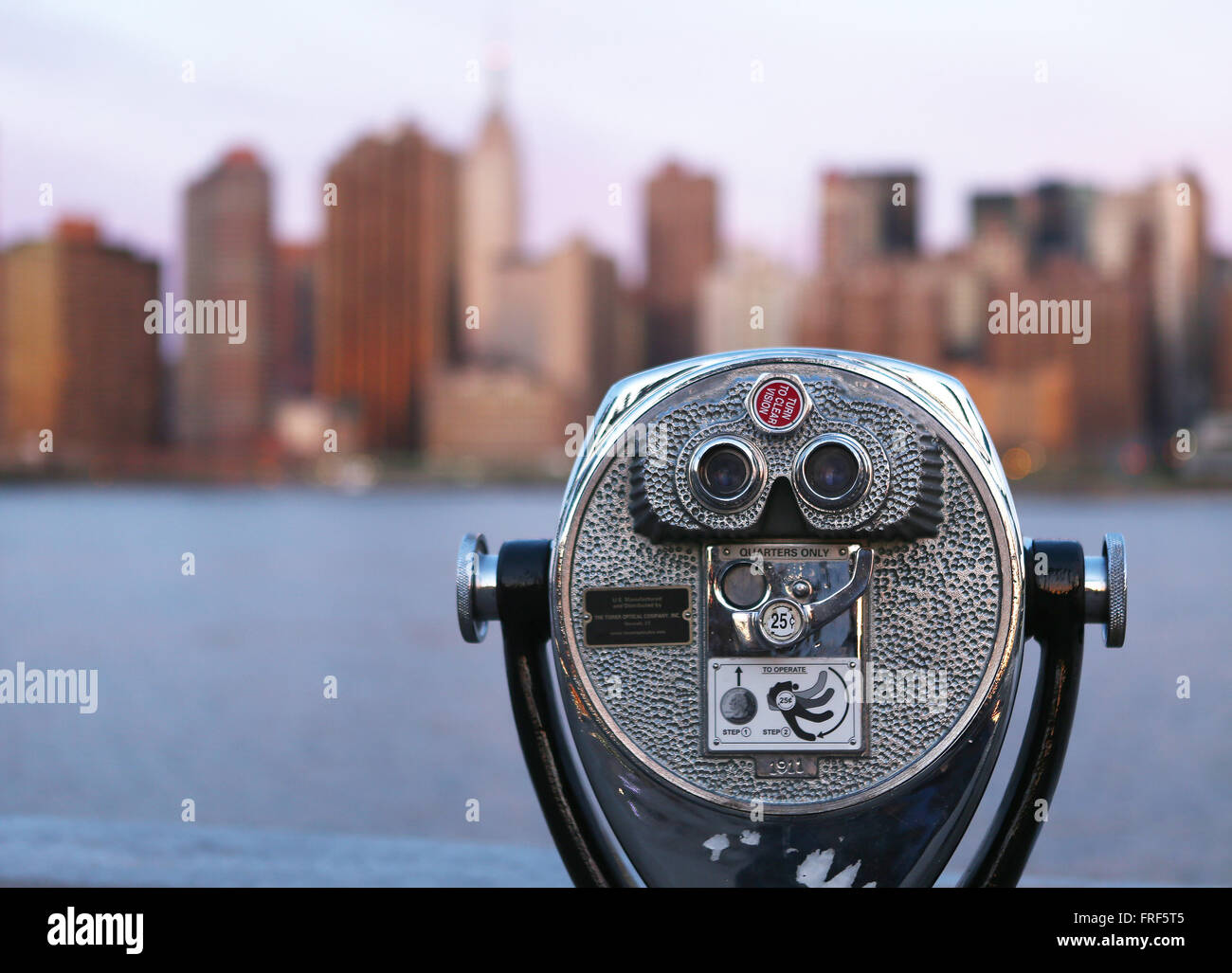 Coin operated binoculars overlook midtown Manhattan as seen from Gantry State Park at sunrise in New York City, New York, United Stock Photo