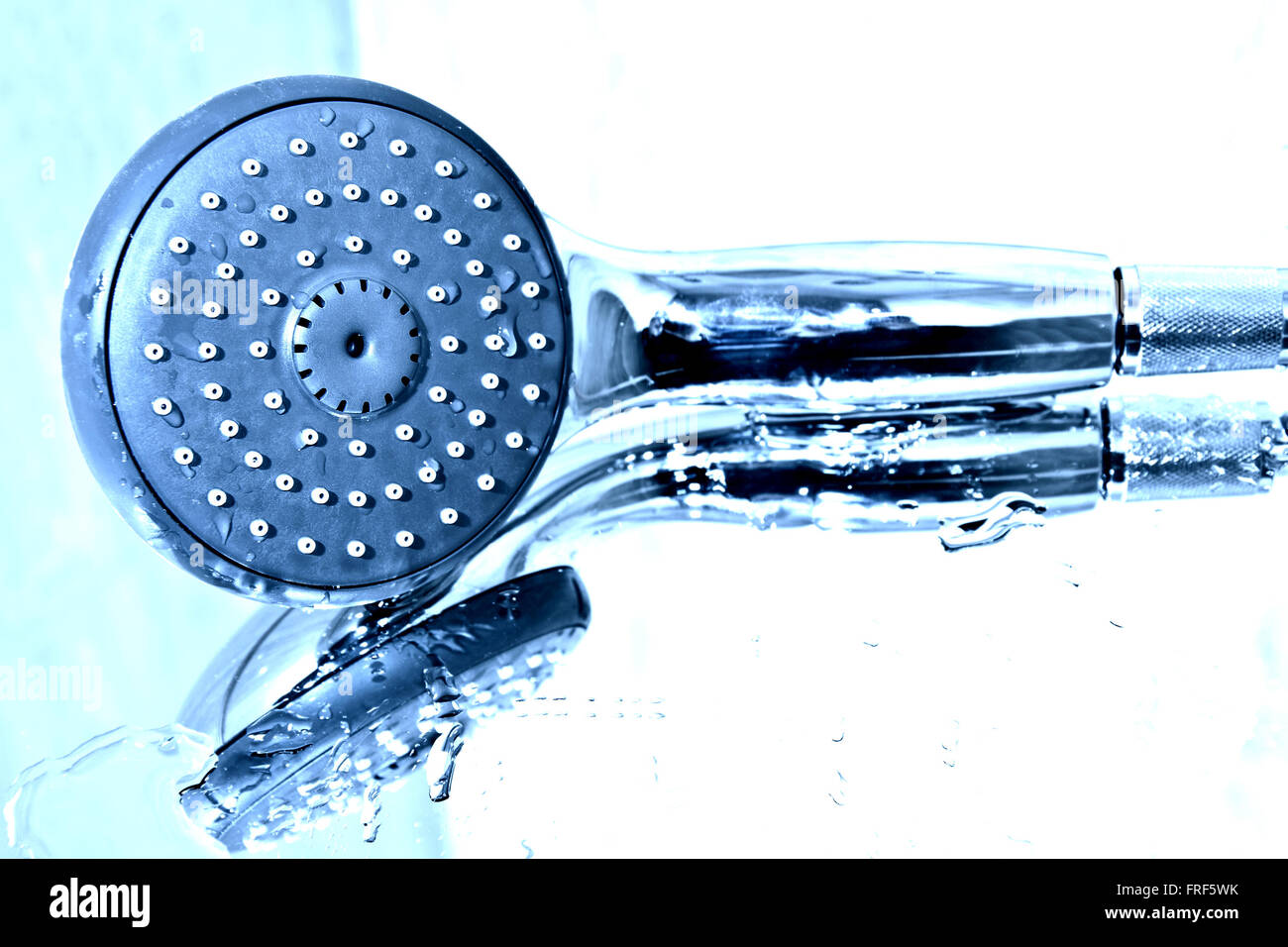 Handshower and water in the bath. Stock Photo