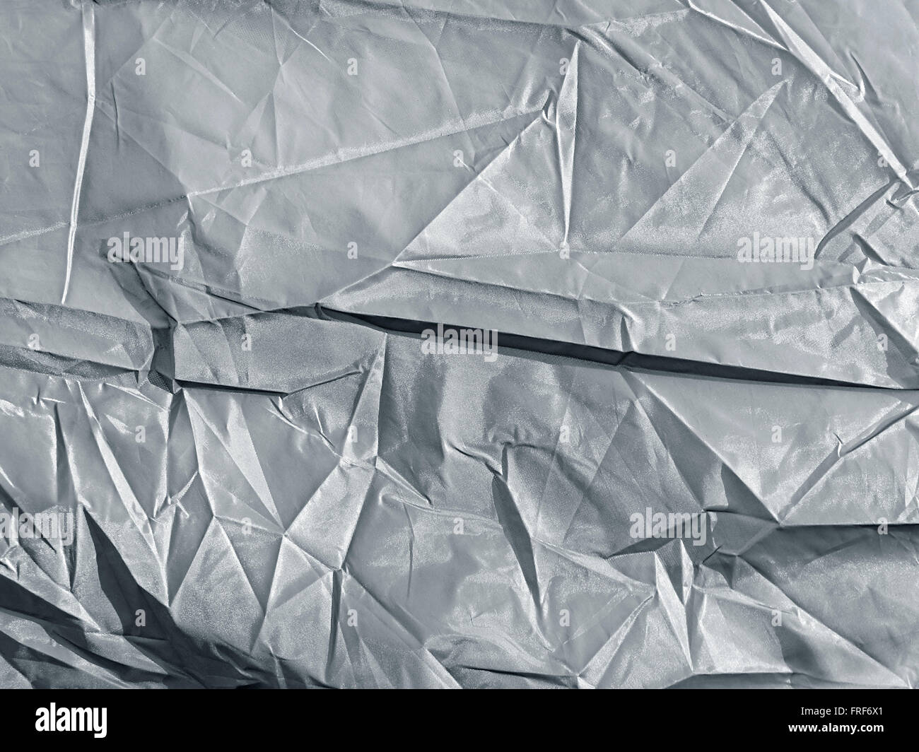 background of crumpled silver synthetic fabric Stock Photo
